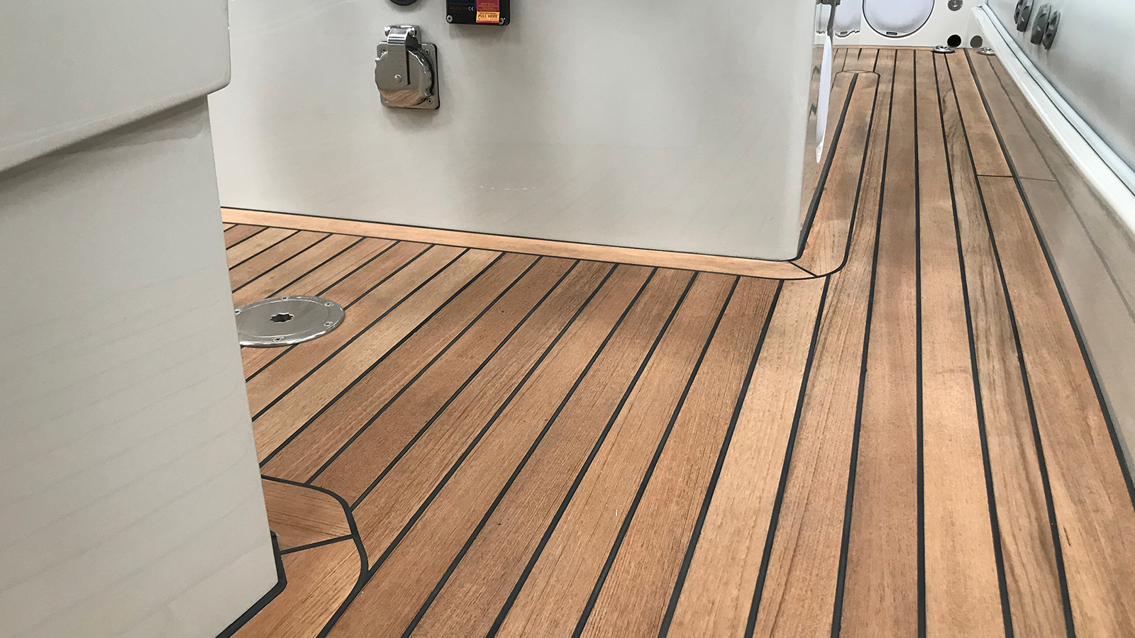 Close-up of wooden flooring on a yacht, showcasing the rich texture and natural beauty of the wood