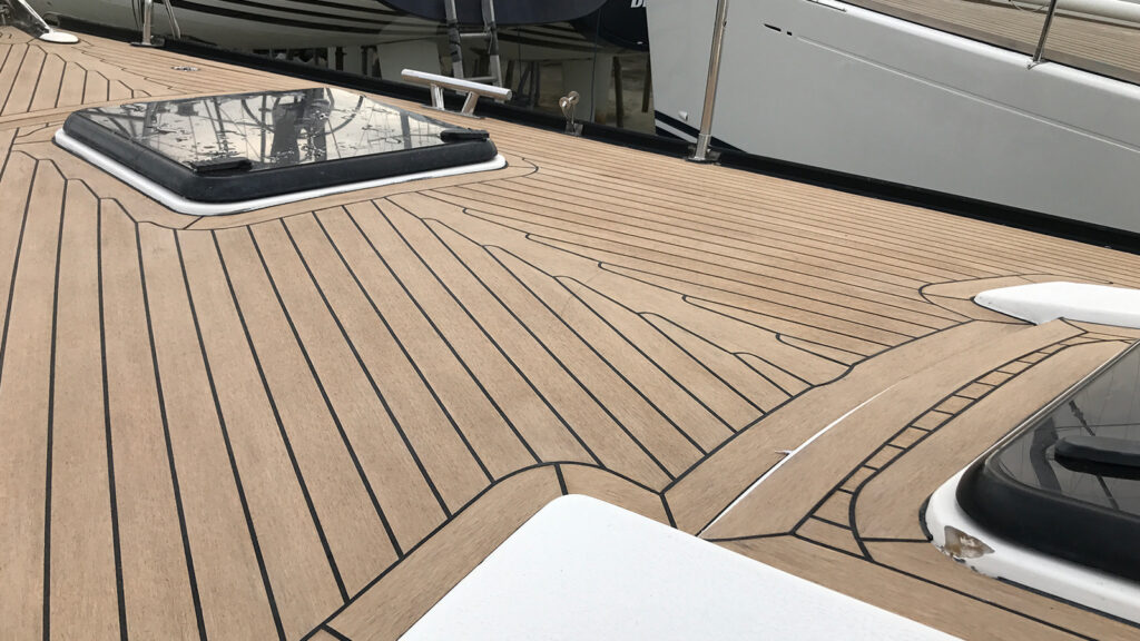 Yacht deck with a view of the wooden floor, basking in the glow of sunlight