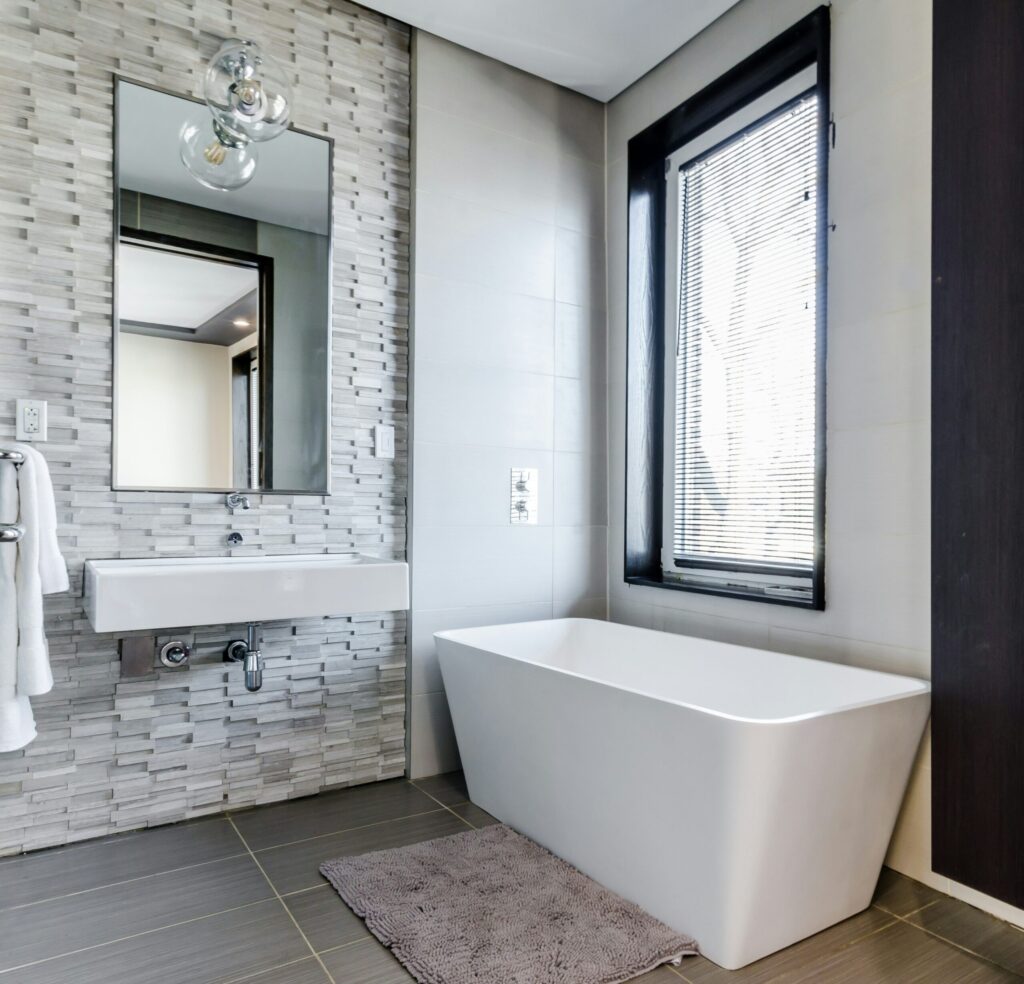 Bathroom-Renovation-white-ceramic-bathtub-near-white-framed-window-scaled
