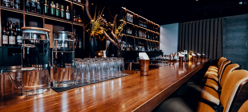 Stylish bar interior renovated by Deco Wood featuring custom joinery, ambient pendant lighting, and luxe finishes.