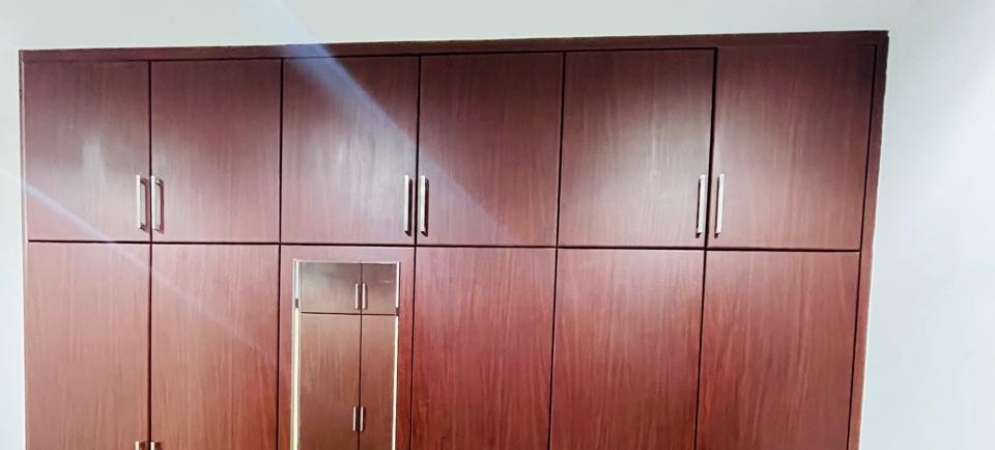 Brightly colored wall and furniture vinyl wrapping installation by Deco Wood in a modern Dubai interior.