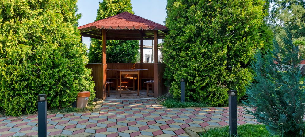 Custom timber-framed wooden gazebo by Deco Wood in a lush Dubai garden.